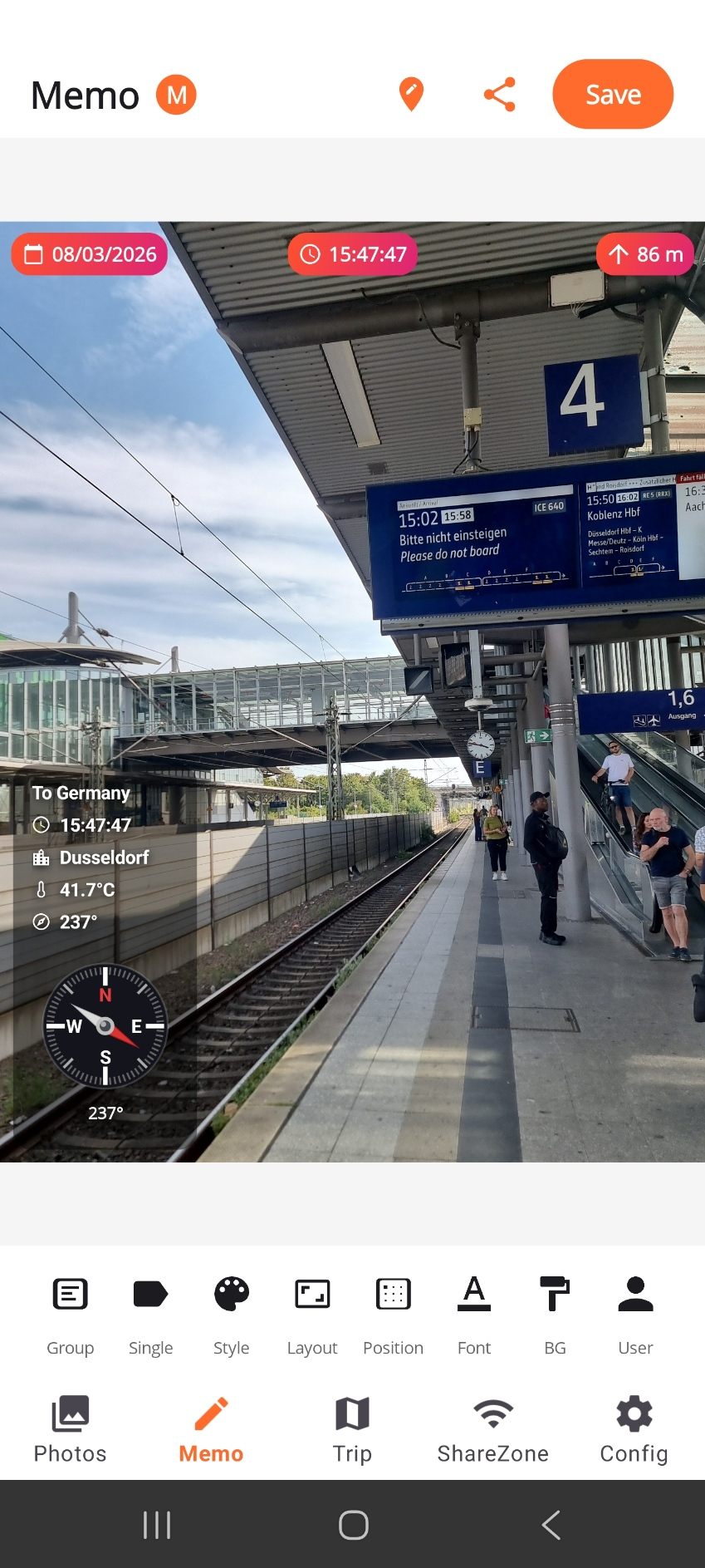 The MemoShare editor showing a railway platform photo stamped with the trip name To Germany, the time, the city Dusseldorf, 41.7 degrees Celsius and a compass.