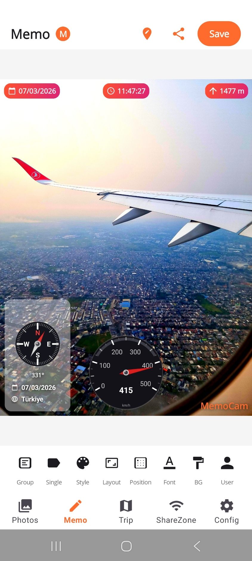 A photo taken from a plane window, stamped with the date, the time, 1477 m altitude, a compass at 331 degrees and a speedometer at 415 km per hour.